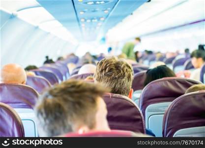 Passengers sit inside airplane - people traveling
