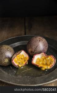 Passion fruit in moody natural light setting with vintage style