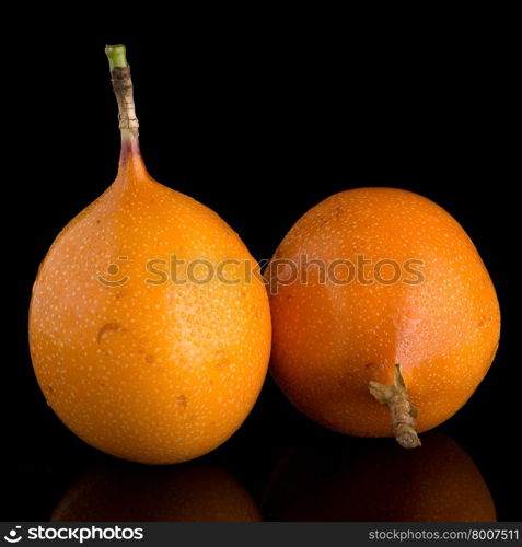 Passion fruit maracuja granadilla on black background.