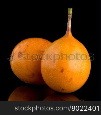 Passion fruit maracuja granadilla on black background.