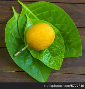 Passion fruits and Green Leaf on Wooden Background