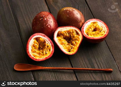 Passion fruits on dark wooden table