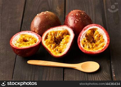 Passion fruits on dark wooden table