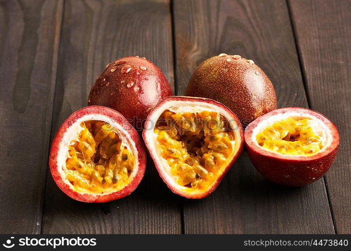 Passion fruits on dark wooden table