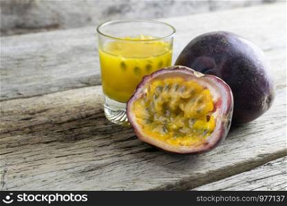 Passion fruits with glass of passion fruit juices on wooden