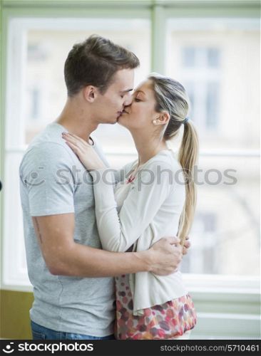 Passionate couple kissing in house