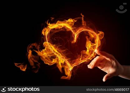 Passionate love heart. Hand touch glowing love hearts symbol on dark background
