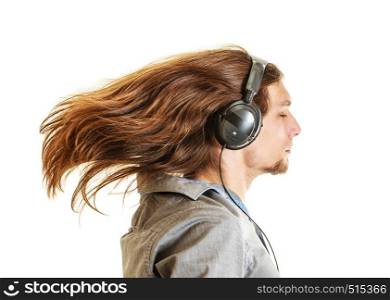 Passionate music lover with long hair flying. Young man listening through headphones relaxing enjyoing. People relax leisure passion concept. Isolated on white background.. Passionate music lover. Man with headphones.