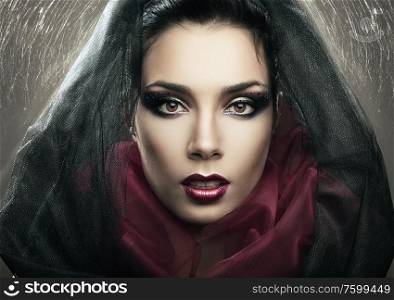 passionate mysterious woman in black hood and web