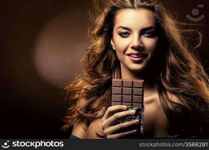 passionate smiling woman and chocolate block