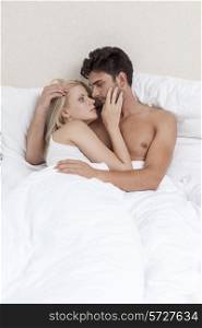 Passionate young couple in bed