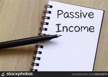 Passive income text concept write on notebook with pen