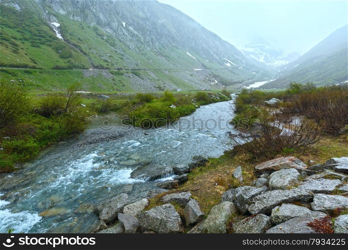 Passo del San Gottardo or St. Gotthard Pass summer misty landscape (Switzerland). Rainy weather