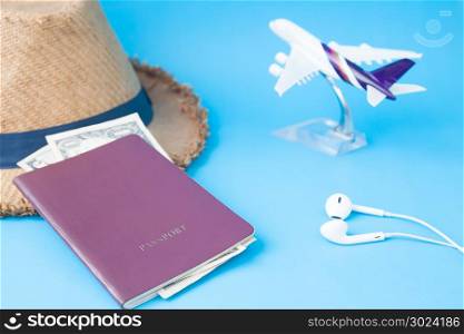 Passport book, money and camera, Travel items with airplane model on blue color background, Travel holiday concept