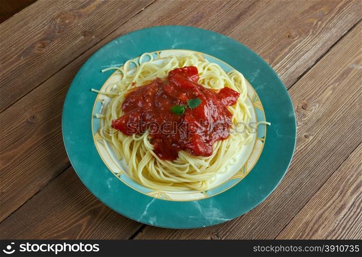 Pasta al pomodoro - Italian food typically prepared with pasta, olive oil, fresh tomatoes, basil
