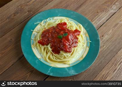Pasta al pomodoro - Italian food typically prepared with pasta, olive oil, fresh tomatoes, basil