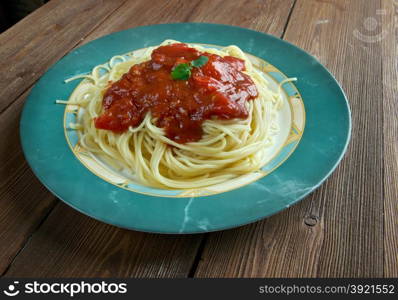 Pasta al pomodoro - Italian food typically prepared with pasta, olive oil, fresh tomatoes, basil