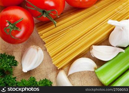 Pasta along with fresh vegetables to make sauce with.
