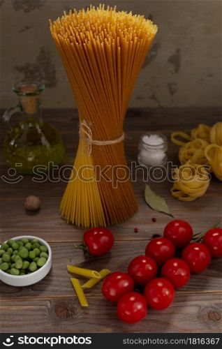 Pasta and food ingredient on wooden table background. Raw pasta assortment of italian food at tabletop
