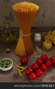 Pasta and food ingredient on wooden table background. Raw pasta assortment of italian food at tabletop