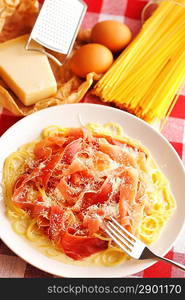 Pasta carbonara over red cloth