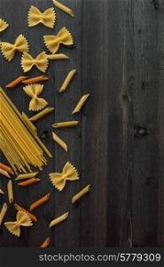 Pasta collection on rustic dark wooden background. Pasta