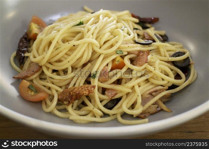 Pasta dish on wooden table, stock photo