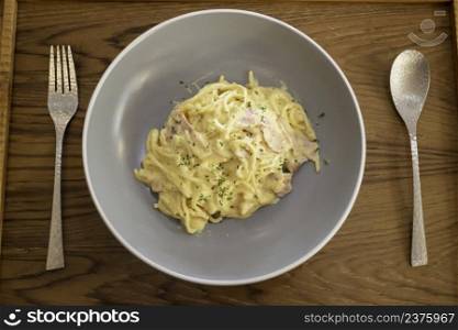 Pasta dish on wooden table, stock photo