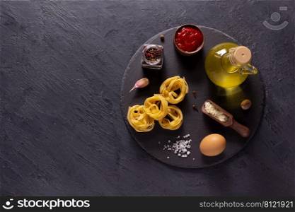 Pasta fettuccine collection food on table background. Raw pasta tagliatelle at slate stone tabletop