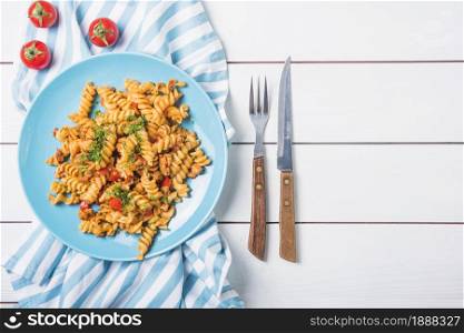 pasta fusilli with tomato cutlery white wooden table . Resolution and high quality beautiful photo. pasta fusilli with tomato cutlery white wooden table . High quality and resolution beautiful photo concept
