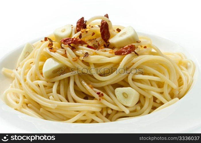 pasta garlic olive oil and red chili pepper closeup on a white dish