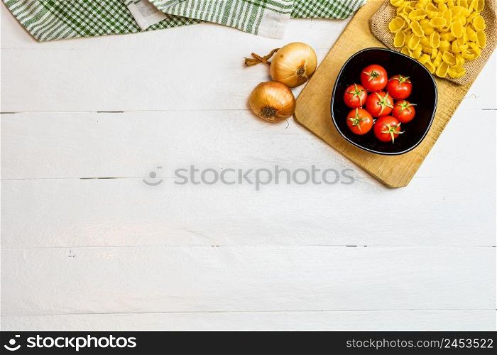 Pasta ingredients isolated. Cherry tomato, pasta, garlic and onions