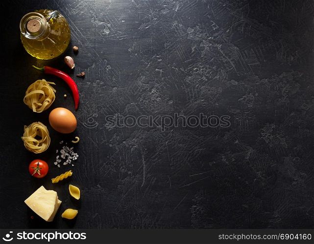 pasta ingredients on black background texture
