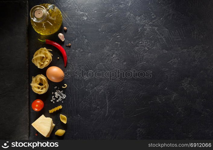 pasta ingredients on black background texture