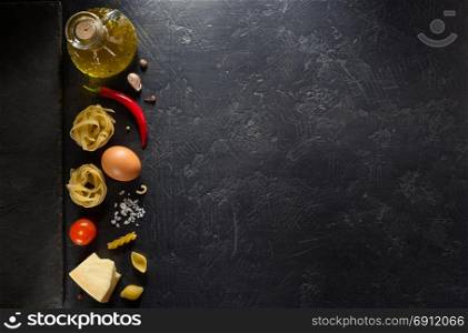 pasta ingredients on black background texture