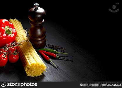 Pasta ingredients on black table