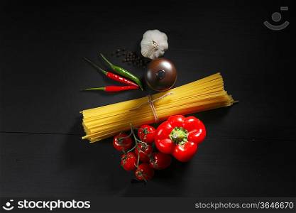 Pasta ingredients on black table