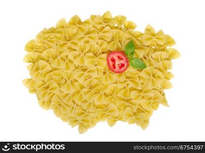 Pasta named Farfalle unprepared decorated with basil leaves and tomato slice. Farfalle with Tomato and Basil