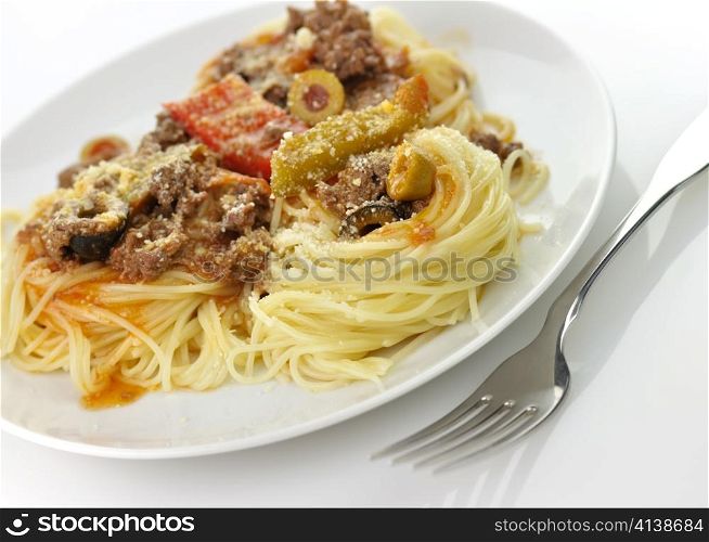 pasta nests with meat and vegetables in a white plate