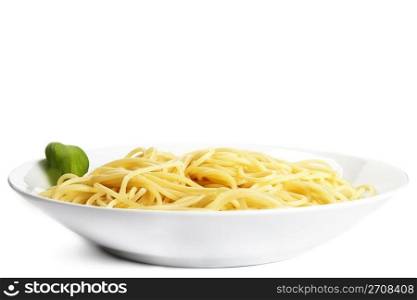 pasta on a plate with basil. some pasta on a plate with basil on white background