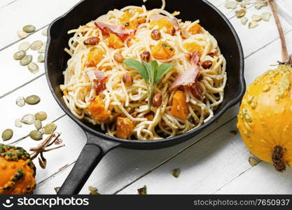 Pasta or spaghetti with pumpkin and bacon.Pasta carbonara.Seasonal autumn food. Autumn pasta with pumpkin and bacon