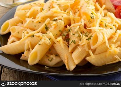 pasta Penne in plate on wooden background