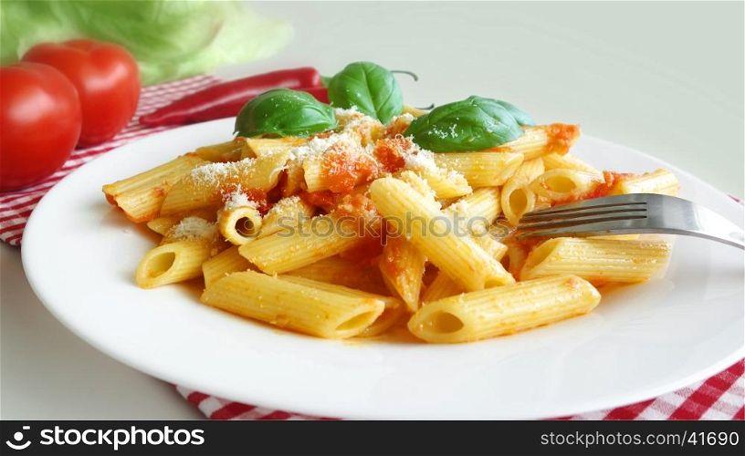 Pasta penne with tomato sauce mediterranean food background.