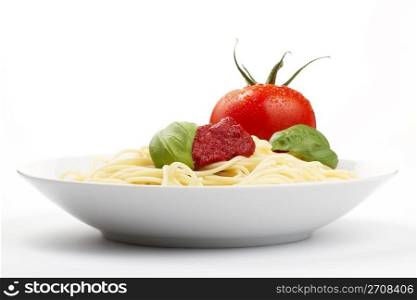 pasta plate with tomato basil and sauce. spaghetti in a plate with tomato, basil and sauce
