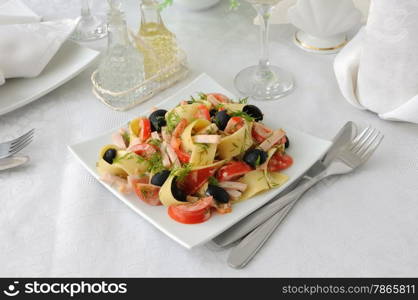 Pasta salad with ham, tomato and olive sauce