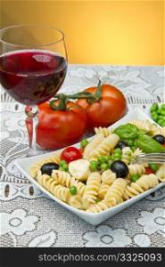 Pasta salad with mozzarella with a glass of red wine