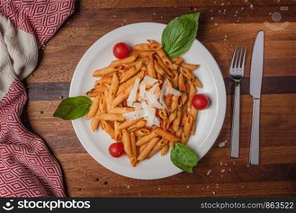 Pasta served with cheese on wooden table background