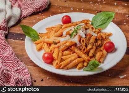 Pasta served with cheese on wooden table background
