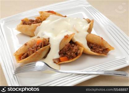 Pasta shells filled with a bolognaise-type meat sauce and topped with a cheesy bechamel.