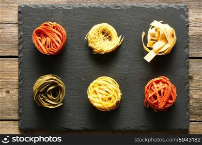 Pasta tagliatelle set over slate background